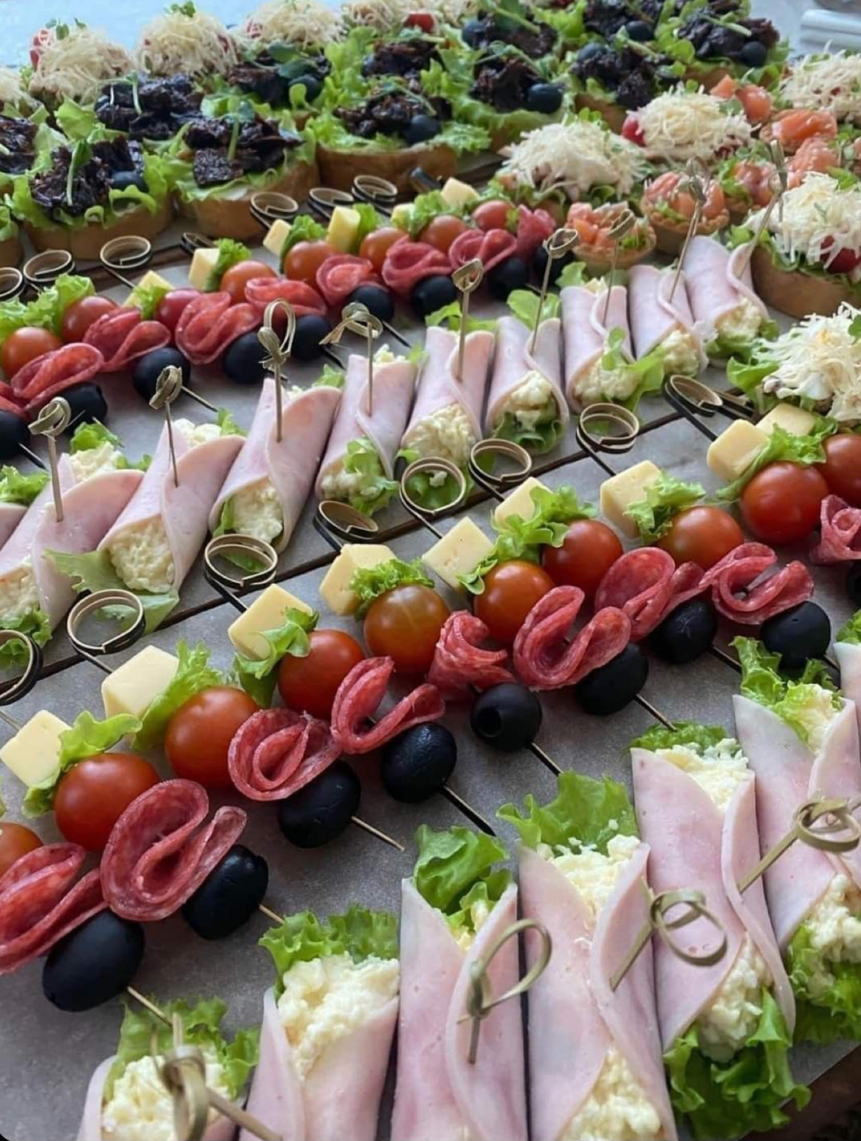 Mini wraps with assorted meats, cheese, and fresh greens.